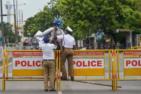 Traffic cops block a road as a preventive measure against the spread of coronavirus in Chennai