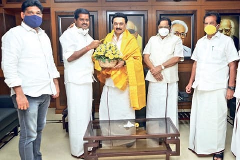 Dr R Lakshmanan greeting DMK president MK Stalin after joining the party in Chennai on Tuesday