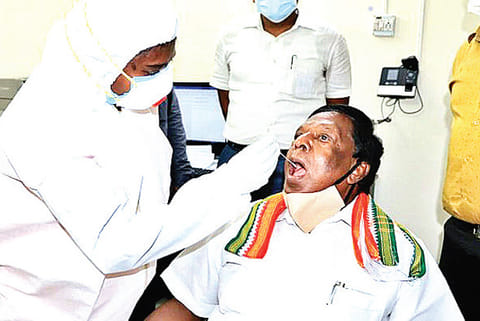 Health workers collect swab samples from Pondy CM. Results on Monday declared that he is negative