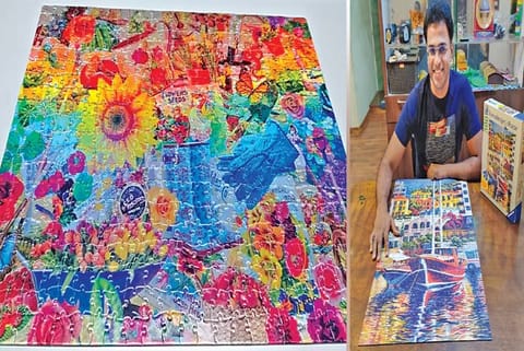 Garden collage foil puzzle; Senthilnathan with a puzzle he has completed