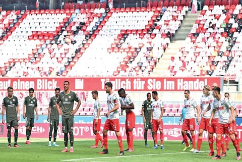 Players of FC Koln and Mainz wait for a corner kick during a Bundesliga match