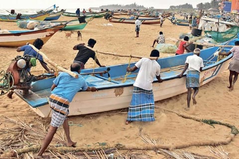 Fishermen move boat to safety following cyclone alert in Mahabalipuram