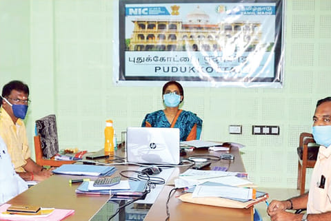 District administration meeting with banner in Hindi and English