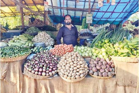 A trader waiting for customers in Gudiyattam on Sunday as he found less takers due to high vegetable