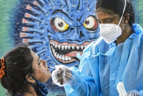 A health worker taking a swab sample (Image credit: PTI)