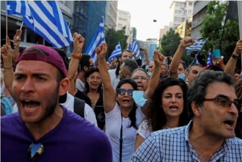 Demonstrators scream slogans against compulsory vaccination (Credit: Reuters)