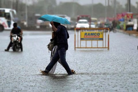 People wade through a water-logged road in Chennai (file photo)