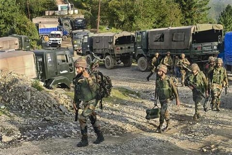 Security personnel patrol at the site of an encounter in Surankote area (Image credit: PTI)