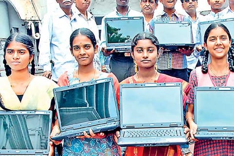 Students with their free laptops (File Photo)