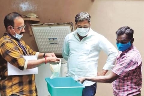 Food safety officials checking meat in the freezer of the sealed hotel