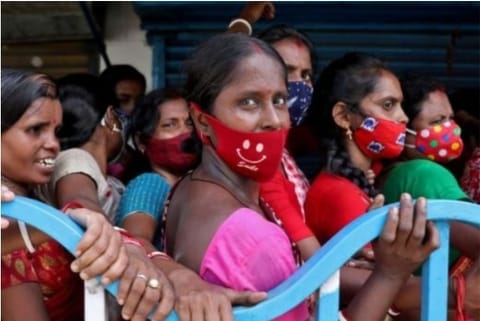 Women stand in a cue to get the second dose of Covishield (Credit: Reuters)