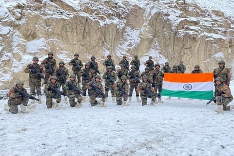 Indian Army troops holding a large tri-colour at the Galwan Valley (Credit: ANI)