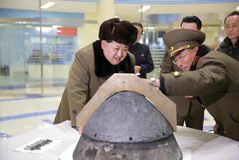 N Korea?s Kim Jong Un looks at a rocket warhead tip after a simulated test of a ballistic missile