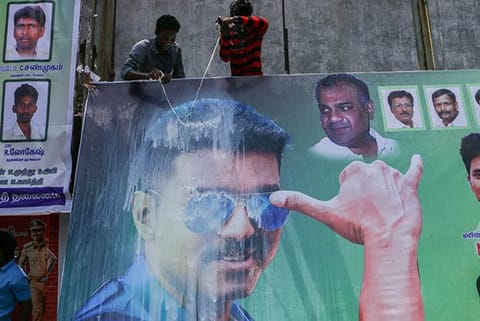 Vijay fans pour milk on his poster at the Woodlands theatre (Photo: Justin George)