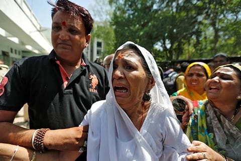 A relative, of one of the convicts involved in the Gulberg riot, breaks down outside the court