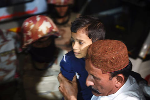 A man carries a boy injured after a bomb blast