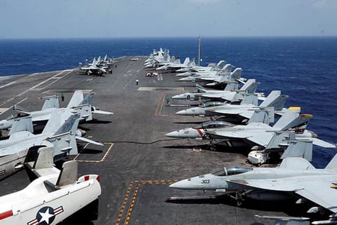U.S. Navy F18 fighter jets are parked on the deck of aircraft carrier USS Carl Vinson