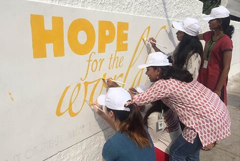 Students of Stella Maris paint the campus walls with eco-friendly messages