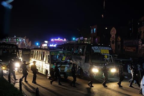 Members of Bangladesh Rapid Action Battalion cross a street