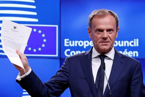 European Council President Donald Tusk shows British Prime Minister Theresa May?s Brexit letter