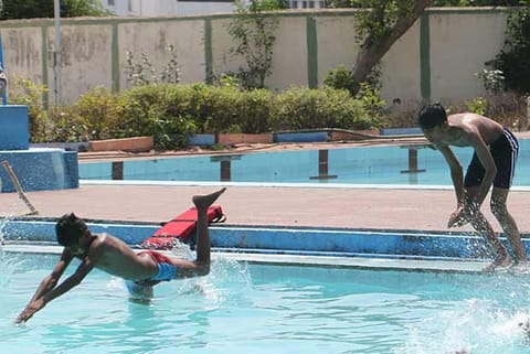 Youth swimming in a pool in the city