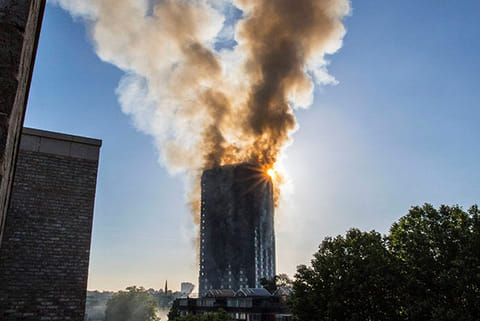 Smoke billows from a high-rise apartment building in west London