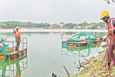 Workers clearing the lake on Friday