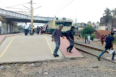 Passengers crossing the railway track at Perungalathur as there is no foot-overbridge or a subway