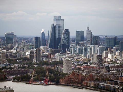 The skyline of London, is seen beyond the River Thames in London, England.