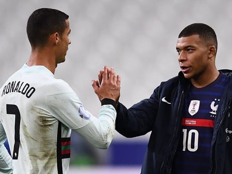 Kylian Mbappe with his idol Cristiano Ronaldo during an International game