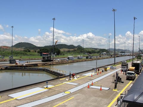 The Panama Canal is an artificial 82km waterway in Panama that connects the Atlantic Ocean with the Pacific Ocean and divides North and South America. The canal that cuts across the Isthmus of Panama facilitates maritime trade as it greatly reduces the time for ships to travel between the Atlantic and Pacific oceans.