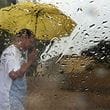  A man walks with umbrella when it rained in Sharjah. For illustrative purposes only.