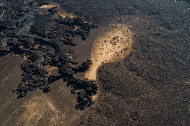Lava flows- the earliest human activity is evidenced in AlUla in Harrat Uwayrid and elsewhere in northwestern Saudi Arabia in Harrat Khaybar. These important volcanic areas comprise two of the largest in Saudi Arabia. Harrat Khaybar includes a spectacular 100-kilometre-long vent system containing lava domes, tuff rings, basaltic cones and the Jabal Qidr stratovolcano. The dramatic lava flows of volcanic events can be seen across the region.