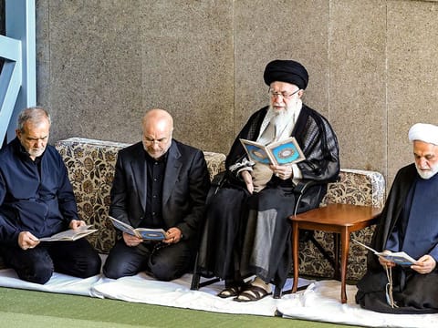 A handout picture provided by the office of Iran's Supreme Leader Ayatollah Ali Khamenei on October 4, 2024, shows him (C), Iran's President Masoud Pezeshkian (L) and Judiciary Chief Mohsen Ejeie (R), reading the Koran during the Friday noon prayer at a mosque in Tehran. 