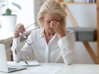 How can menopause both ease and worsen autoimmune conditions in women?