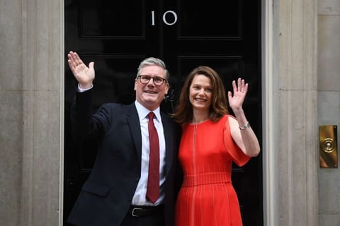 Keir Starmer, UK prime minister, and Victoria Starmer, his wife, after he delivered the first speech of his premiership, following the general election, outside 10 Downing Street in London, UK, on Friday, July 5, 2024. Keir Starmer’s Labour Party won the UK general election and is on course for a huge parliamentary majority with votes still being counted, a result that upends British politics after Rishi Sunak’s Conservatives imploded. Photographer: Chris J. Ratcliffe/Bloomberg