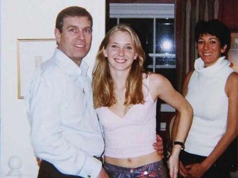 An undated handout photo taken at an undisclosed location and released on August 9, 2021 by the United States District County for the Southern District of New York shows (L-R) the former Prince Andrew, Virginia Giuffre, and Ghislaine Maxwell posing for a photo.