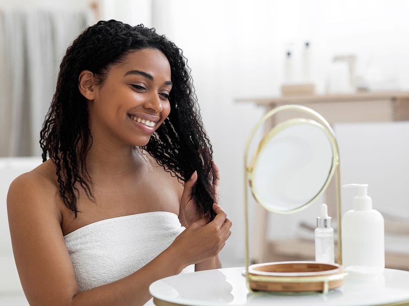 Person washing curly hair