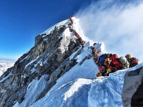File photo: Heavy traffic of mountain climbers lining up to stand at the summit of Mount Everest, May 22, 2019.  