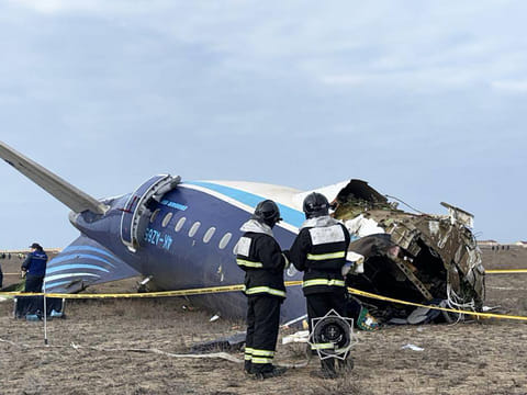 In this handout picture released by Kazakhstan's emergency situations ministry, emergency specialists work at the crash site of an Azerbaijan Airlines passenger jet near the western Kazakh city of Aktau on December 25, 2024. 