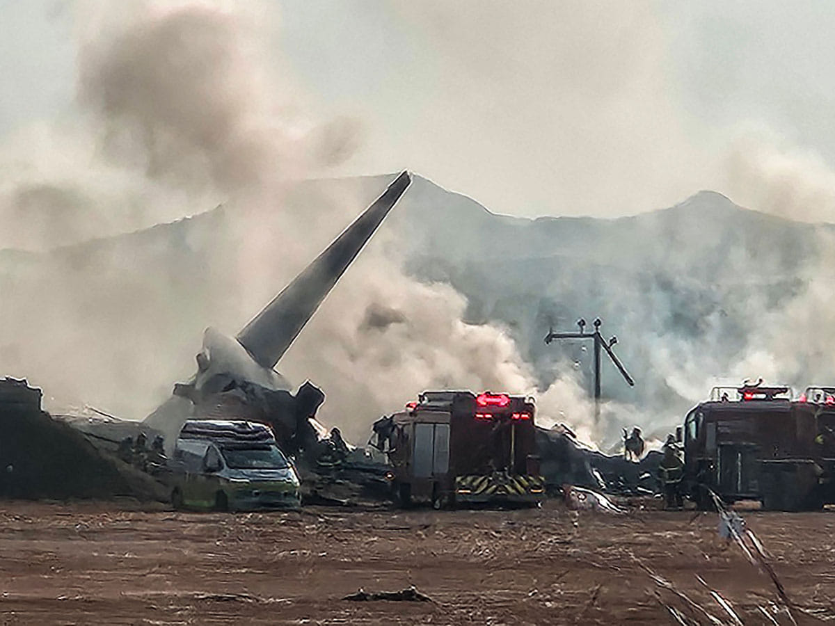 Smoke rises from the tail section of a Jeju Air Boeing 737-800 series aircraft after the plane crashed and burst into flames at Muan International Airport in South Jeolla Province, some 288 kilometres southwest of Seoul on December 29, 2024.