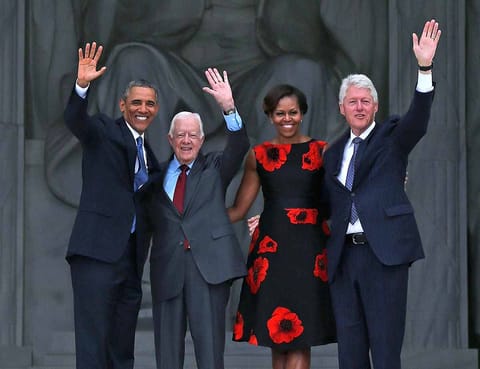 US President Barack Obama (L) stands with First Lady Michelle Obama (2nd-R) and former presidents Jimmy Carter (2nd-L) and Bill Clinton during the ceremony to commemorate the 50th anniversary of the March on Washington for Jobs and Freedom August 28, 2013 in Washington, DC.