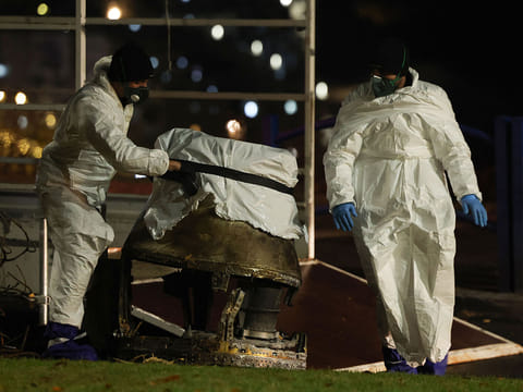 Israeli security forces inspect the fragments of a Houthi ballistic missile launched from Yemen in the central Israeli town of Bet Shemesh, near Jerusalem, on December 31, 2024.