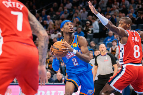 Shai Gilgeous-Alexander (centre) of Oklahoma City Thunder drives to the basket against Kris Dunn of Los Angeles Clippers during the third quarter on Thursday.