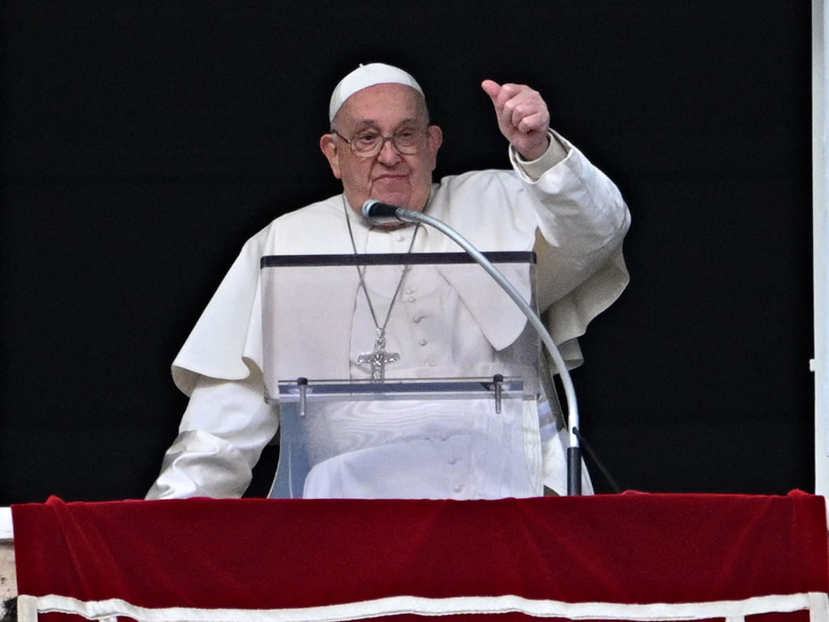 Pope Francis gestures to the crowd from the window of the Apostolic Palace overlooking St Peter's Square during the Epiphany Angelus prayer, in the Vatican, on January 6, 2025. 