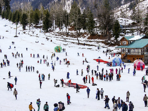 Tourists enjoy after fresh snowfall, at the Solang Valley in Manali.