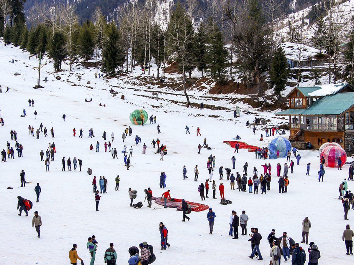 Tourists enjoy after fresh snowfall, at the Solang Valley in Manali.