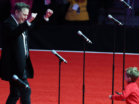 Elon Musk and his son X appear on stage at President-Elect Donald Trump's victory rally at the Capital One Arena on January 19, 2025 in Washington, DC. 