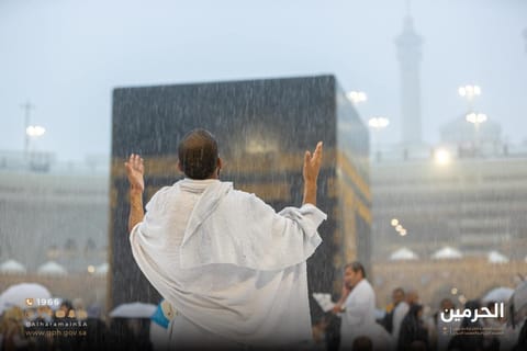 A pilgrim prays amid heavy rains in the Grand Mosque in Mecca. 