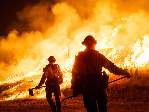 Firefighters work as the Hughes Fire burns on January 22, 2025 in Castaic, California. 